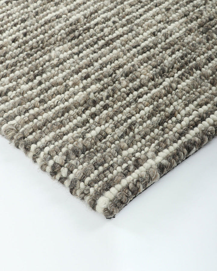 Karaka Floor Rug Create a casualÂ yetÂ refinedÂ look with the natural texture of our KarakaÂ floor rug. Crafted from 100% wool, each rug has been carefully woven by skilled artisans in a tight loop pile design. Natural wool, flecked with grey and black, m