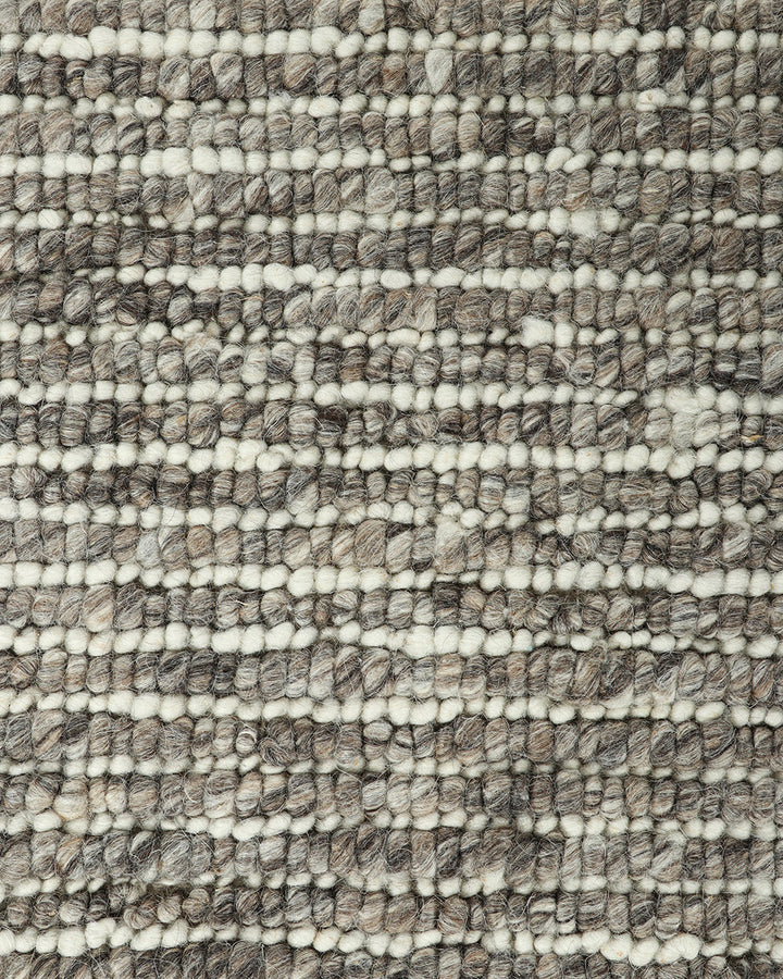 Karaka Floor Rug Create a casualÂ yetÂ refinedÂ look with the natural texture of our KarakaÂ floor rug. Crafted from 100% wool, each rug has been carefully woven by skilled artisans in a tight loop pile design. Natural wool, flecked with grey and black, m