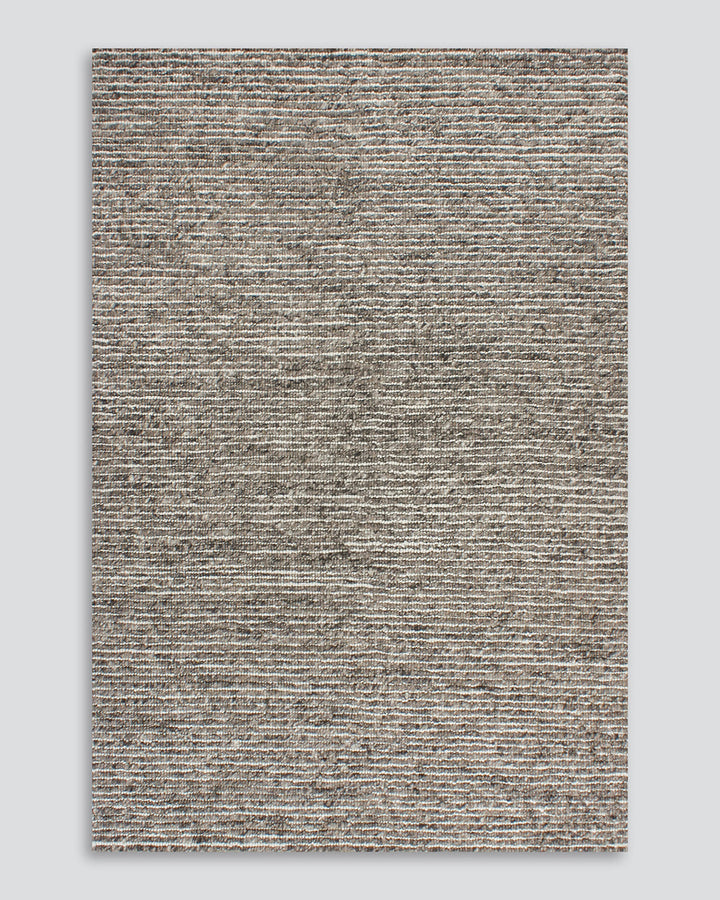 Karaka Floor Rug Create a casualÂ yetÂ refinedÂ look with the natural texture of our KarakaÂ floor rug. Crafted from 100% wool, each rug has been carefully woven by skilled artisans in a tight loop pile design. Natural wool, flecked with grey and black, m