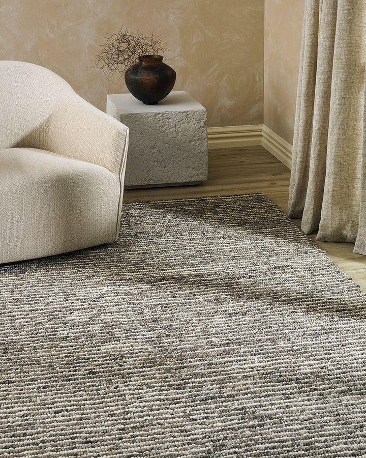 Karaka Floor Rug Create a casualÂ yetÂ refinedÂ look with the natural texture of our KarakaÂ floor rug. Crafted from 100% wool, each rug has been carefully woven by skilled artisans in a tight loop pile design. Natural wool, flecked with grey and black, m