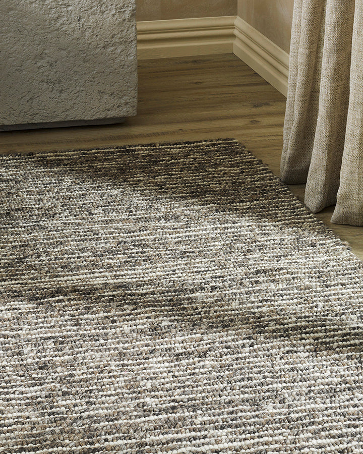 Karaka Floor Rug Create a casualÂ yetÂ refinedÂ look with the natural texture of our KarakaÂ floor rug. Crafted from 100% wool, each rug has been carefully woven by skilled artisans in a tight loop pile design. Natural wool, flecked with grey and black, m