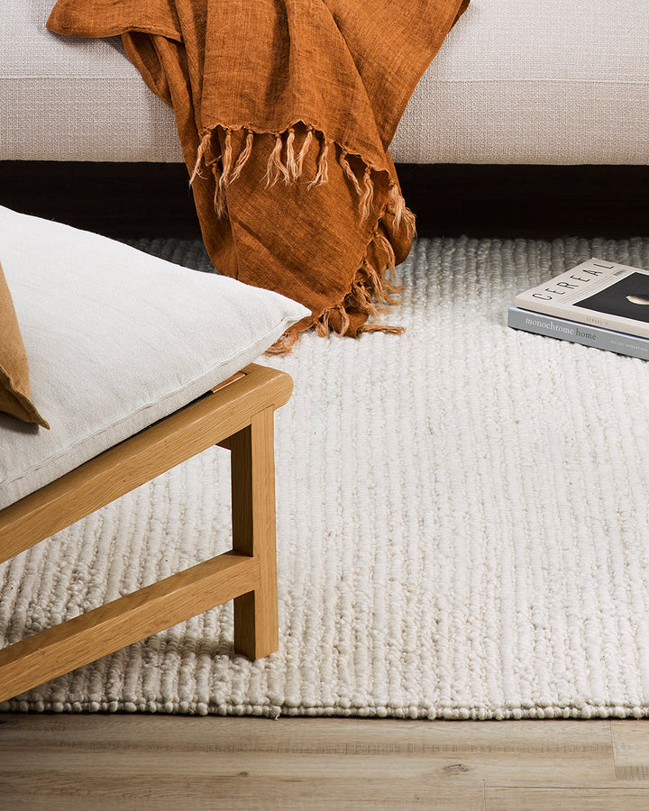 Karaka Floor Rug Create a casualÂ yetÂ refinedÂ look with the natural texture of our KarakaÂ floor rug. Crafted from 100% wool, each rug has been carefully woven by skilled artisans in a tight loop pile design. Natural wool, flecked with grey and black, m