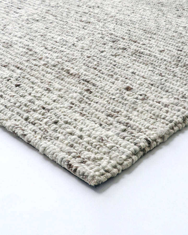 Karaka Floor Rug Create a casualÂ yetÂ refinedÂ look with the natural texture of our KarakaÂ floor rug. Crafted from 100% wool, each rug has been carefully woven by skilled artisans in a tight loop pile design. Natural wool, flecked with grey and black, m