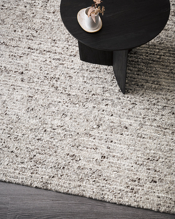 Karaka Floor Rug Create a casualÂ yetÂ refinedÂ look with the natural texture of our KarakaÂ floor rug. Crafted from 100% wool, each rug has been carefully woven by skilled artisans in a tight loop pile design. Natural wool, flecked with grey and black, m