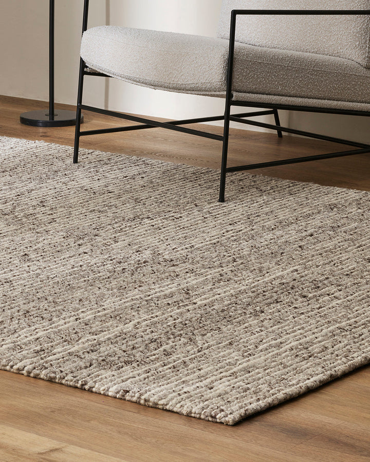 Karaka Floor Rug Create a casualÂ yetÂ refinedÂ look with the natural texture of our KarakaÂ floor rug. Crafted from 100% wool, each rug has been carefully woven by skilled artisans in a tight loop pile design. Natural wool, flecked with grey and black, m