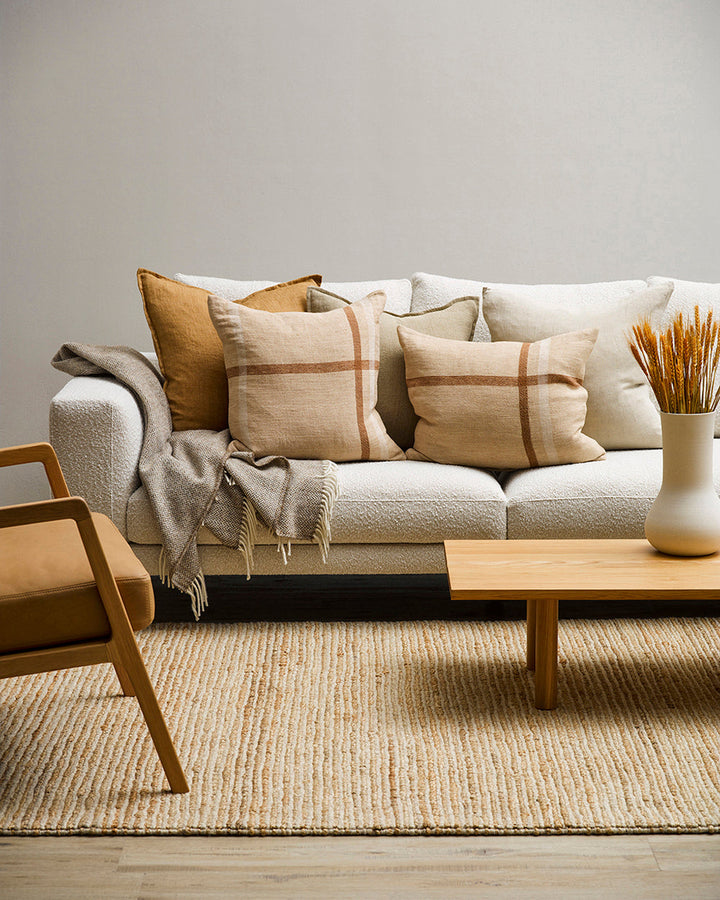 Keswick Cushion Country charm is reinterpreted for urban living in the pared-back design of our Keswick cushion. Tones of treacle, ivory and taupe are woven into an offset, oversized plaid, embodying the â€˜Rustic Retreatâ€™ trend. Comfort and quality go