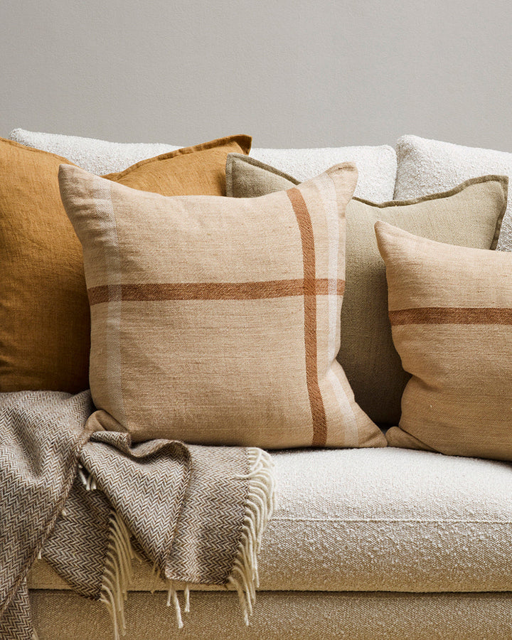 Keswick Cushion Country charm is reinterpreted for urban living in the pared-back design of our Keswick cushion. Tones of treacle, ivory and taupe are woven into an offset, oversized plaid, embodying the â€˜Rustic Retreatâ€™ trend. Comfort and quality go