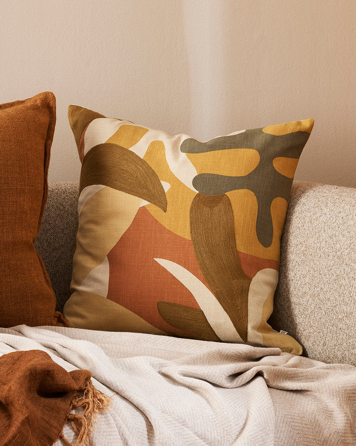 Labyrinth Cushion Inspired by 1950's jungle forms, the design here is confident, with simplified leaf motifs screen-printed onto an ecru ground. Colours are rich, with gentle texture added through sections of matte embroidery. Pair with sister cushion Mas