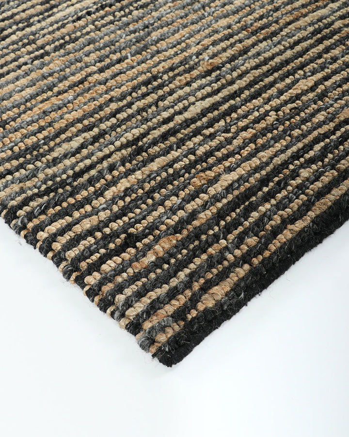 Lima Floor Rug Invite simple, raw texture into your space with the beauty of natural fibres. Handwoven from a stunning blend of jute and wool, the Lima features a stripe pattern in a striking charcoal colourway. An excellent all-rounder for a wide range o