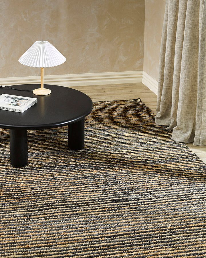 Lima Floor Rug Invite simple, raw texture into your space with the beauty of natural fibres. Handwoven from a stunning blend of jute and wool, the Lima features a stripe pattern in a striking charcoal colourway. An excellent all-rounder for a wide range o