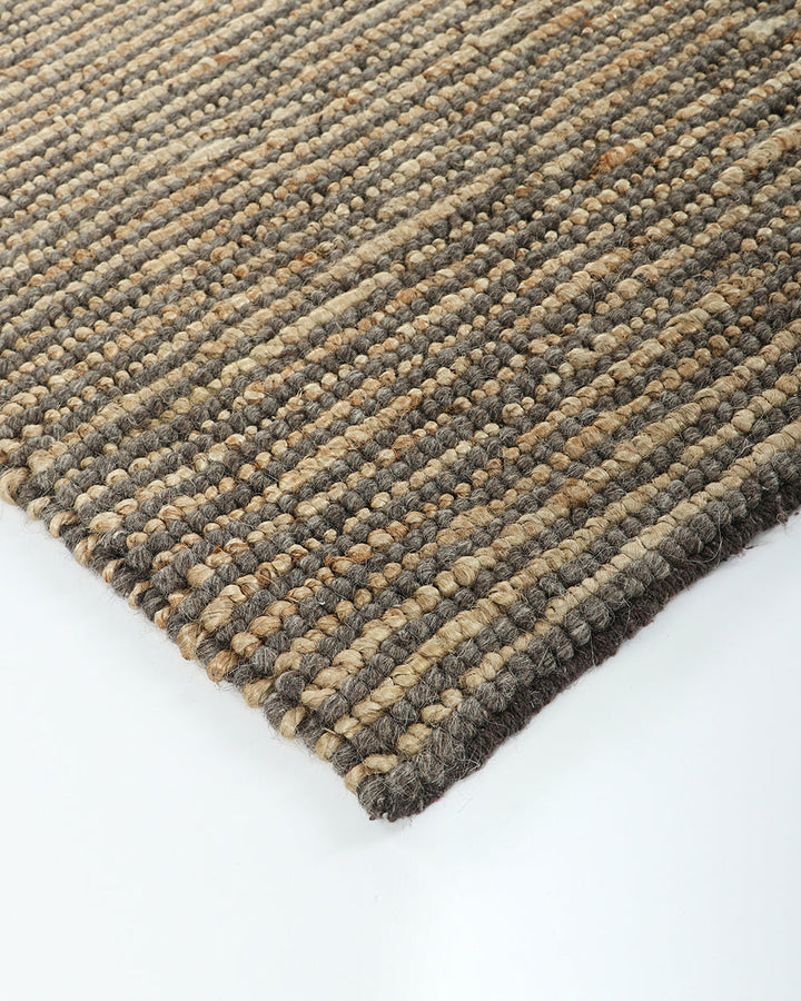 Lima Floor Rug Invite simple, raw texture into your space with the beauty of natural fibres. Handwoven from a stunning blend of jute and wool, the Lima features a stripe pattern in a striking charcoal colourway. An excellent all-rounder for a wide range o