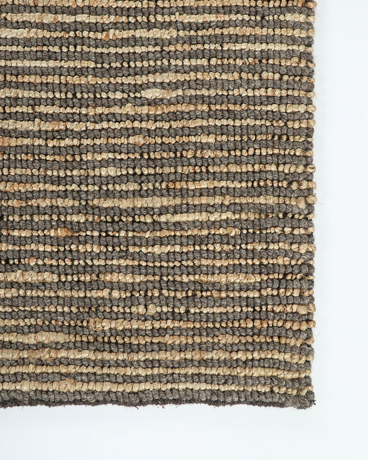 Lima Floor Rug Invite simple, raw texture into your space with the beauty of natural fibres. Handwoven from a stunning blend of jute and wool, the Lima features a stripe pattern in a striking charcoal colourway. An excellent all-rounder for a wide range o