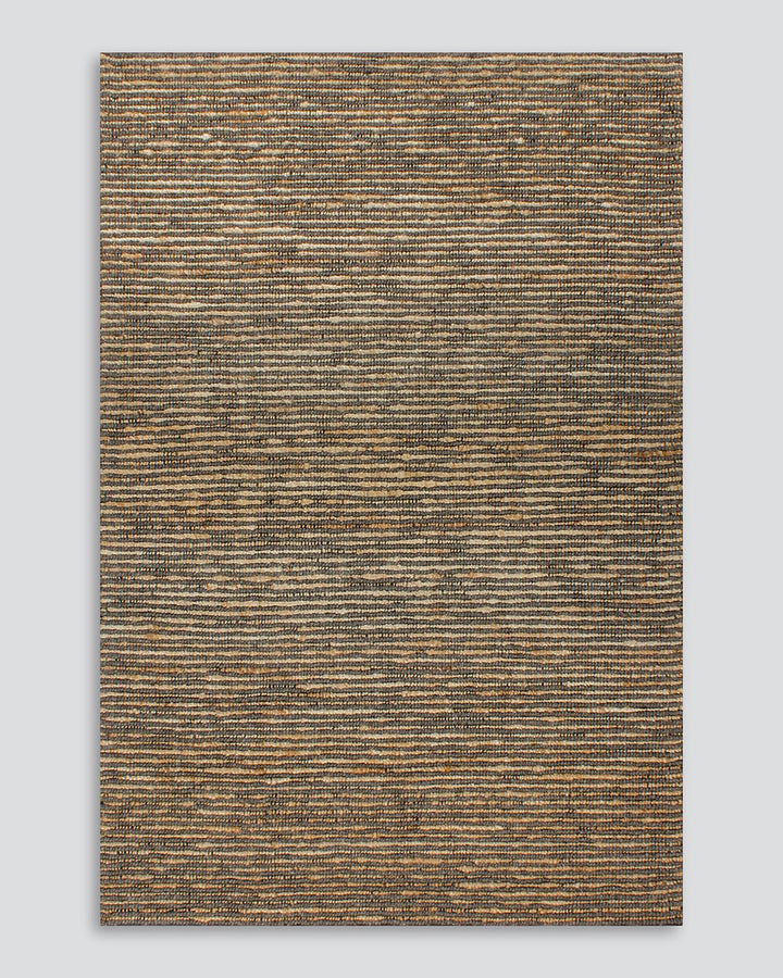 Lima Floor Rug Invite simple, raw texture into your space with the beauty of natural fibres. Handwoven from a stunning blend of jute and wool, the Lima features a stripe pattern in a striking charcoal colourway. An excellent all-rounder for a wide range o