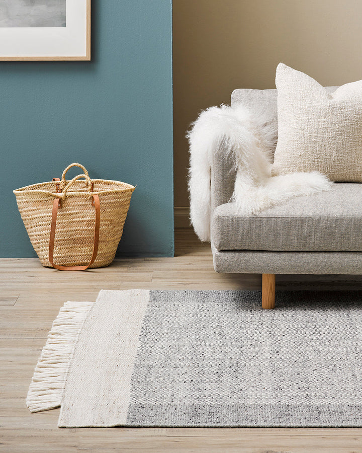 Lindis Floor Rug Add understated chic to your interior with the exceptional design of our Lindis floor rug. Handwoven by skilled artisans, tonal fibres are woven in a classic 1-1 structure, creating a refined and interesting border design. Fringing on bot