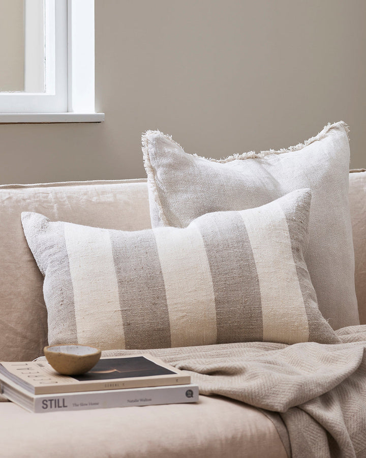 Lowburn Cushion Create a calming, nurturing space with a modern take on coastal style. Perfect for summer, our Lowburn cushion brings breezy and timeless style to interiors. Featuring a wide linear design in textural linen, this lumbar style cushion has b