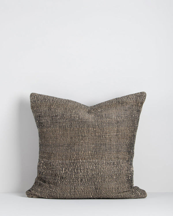 Magnus Cushion The essence of crafted elegance is celebrated in the delicate, irregular surface of the Magnus. Handwoven by skilled artisan makers, the intricate weave reveals the natural grains in the yarn, creating a captivating fabric with beautiful te