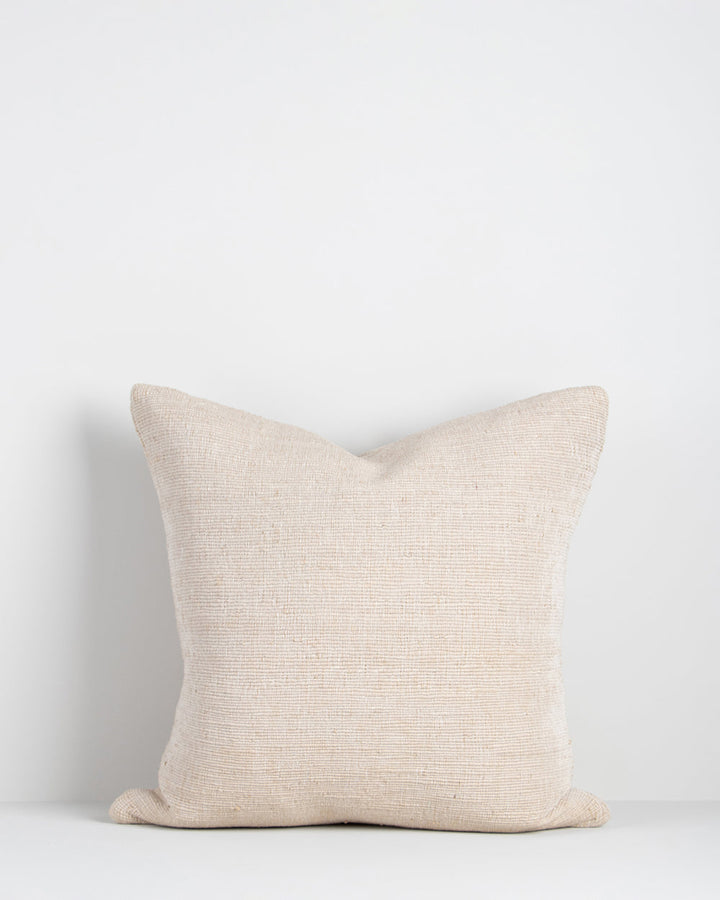 Magnus Cushion The essence of crafted elegance is celebrated in the delicate, irregular surface of the Magnus. Handwoven by skilled artisan makers, the intricate weave reveals the natural grains in the yarn, creating a captivating fabric with beautiful te