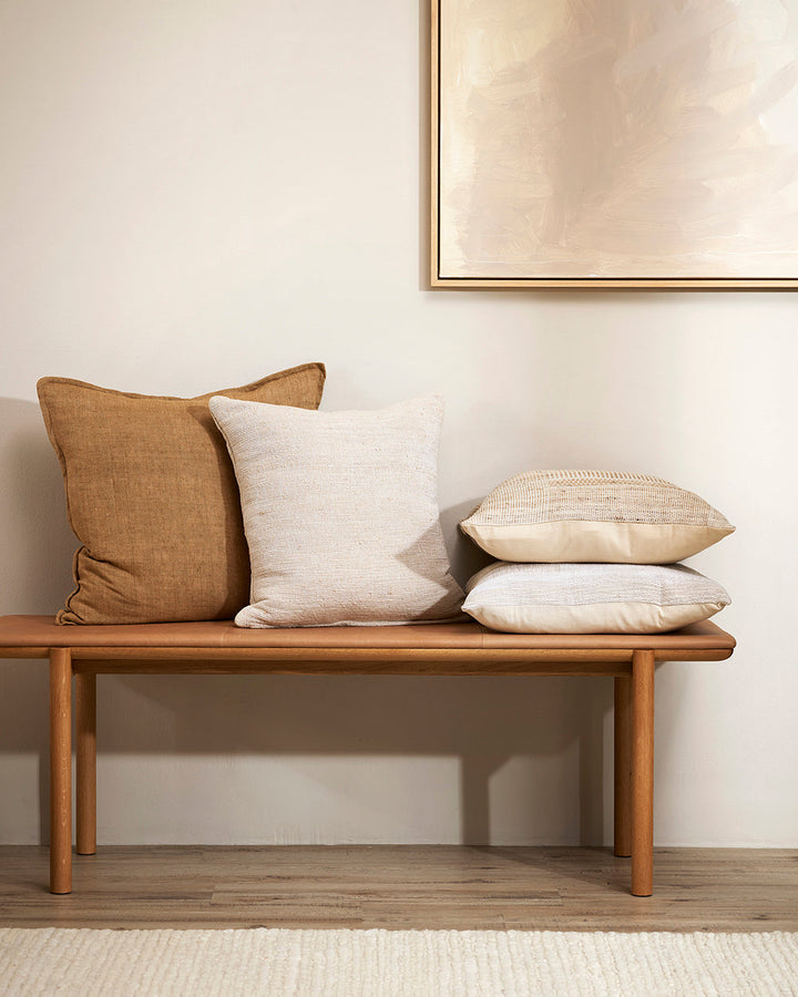 Magnus Cushion The essence of crafted elegance is celebrated in the delicate, irregular surface of the Magnus. Handwoven by skilled artisan makers, the intricate weave reveals the natural grains in the yarn, creating a captivating fabric with beautiful te