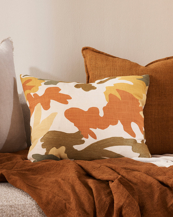 Maschera Cushion Inspired by 1950's jungle forms, the design here is confident, with simplified leaf motifs screen-printed onto an ecru ground. Colours are rich, with gentle texture added through sections of matte embroidery. Pair with sister cushion Laby