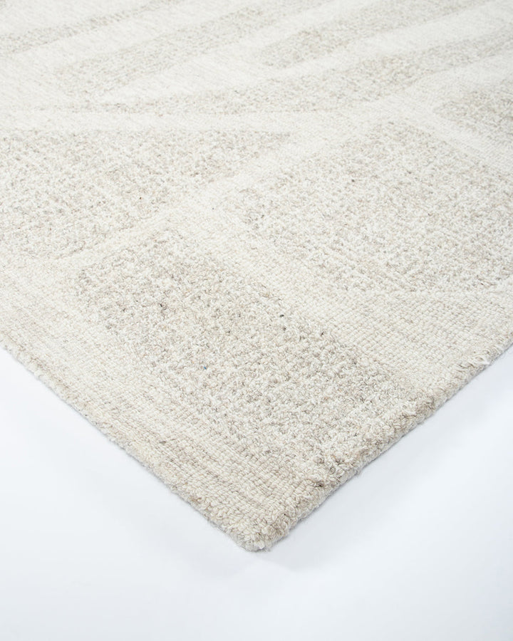 Maya Floor Rug Create a welcoming space with understated design in pure 100% wool. Inspired by the mineral lines in coastal rocks, the Maya rug’s abstract design and sand tones evoke a natural sense of warmth and style. Soft and supportive underfoot, the