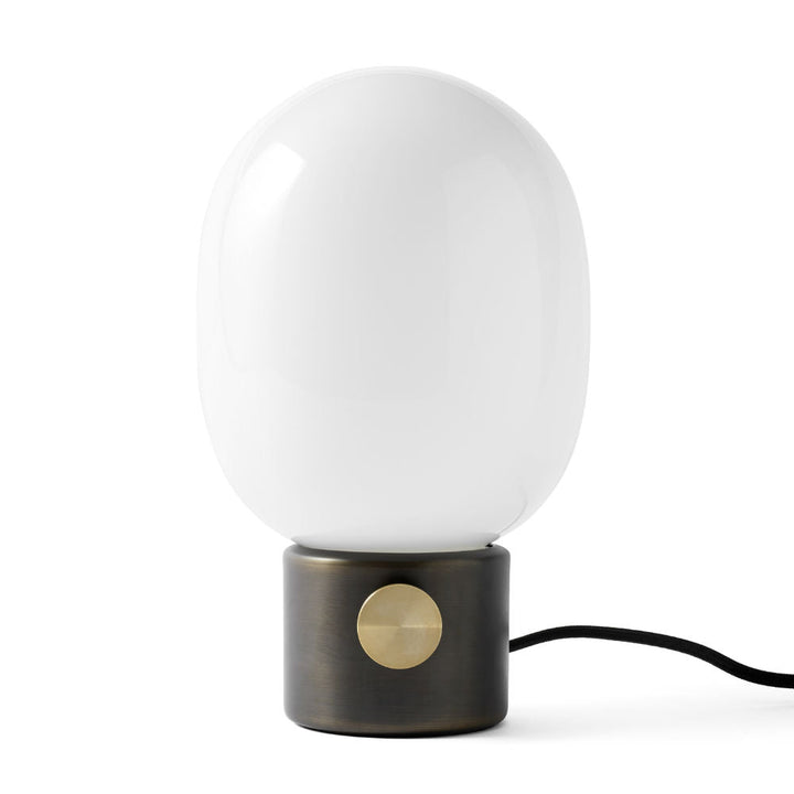 Audo CPH JWDA Table Lamp by Audo Copenhagen - The JWDA Lamp is an immediate statement piece, combining sculptural appeal with room-transforming presence. Its design features a striking balance between the fragile, curved glass and the robust metal base, c