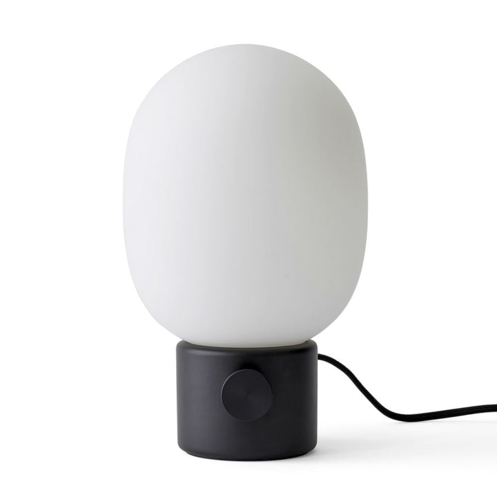 Audo CPH JWDA Table Lamp by Audo Copenhagen - The JWDA Lamp is an immediate statement piece, combining sculptural appeal with room-transforming presence. Its design features a striking balance between the fragile, curved glass and the robust metal base, c