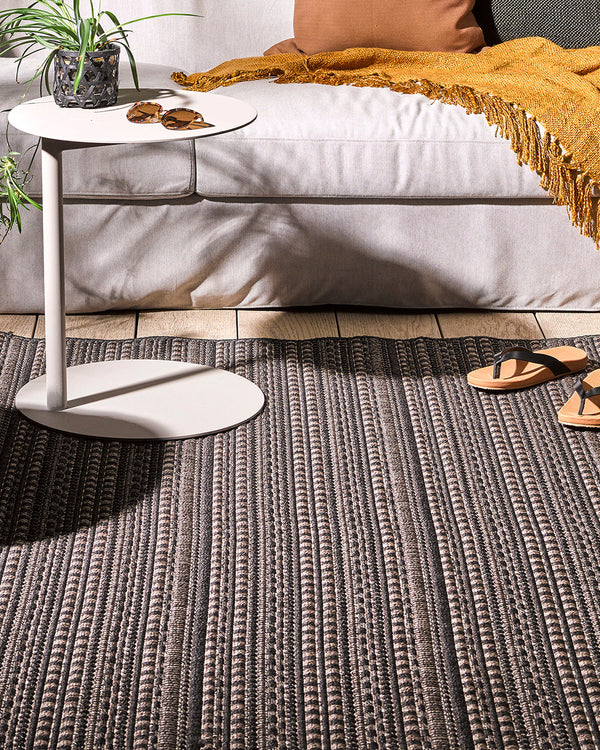 Mendoza Floor Rug Suitable for use both in and outdoors, the Mendozaâ€™s finely patterned weave and timeless colourway provides the perfect base for styling a refined exterior space. The understated design makes this piece easy to pair with flooring and f