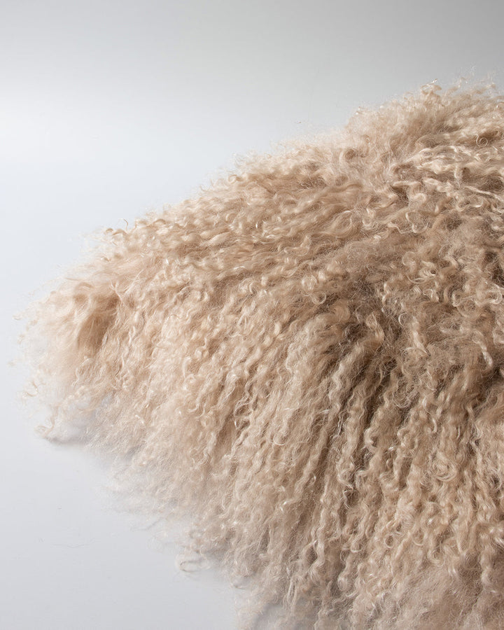 Meru Tibetan Lamb Cushion Bring a cosy, inviting feel to a room with the impossibly soft texture of Tibetan lamb fur. Gorgeously shaggy with a natural curl, the Meru engages senses with its sumptuous tactility, and restful silver tone. Style with matching