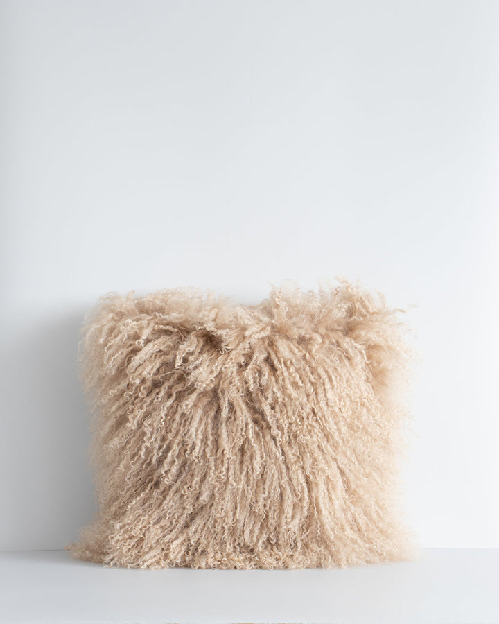 Meru Tibetan Lamb Cushion Bring a cosy, inviting feel to a room with the impossibly soft texture of Tibetan lamb fur. Gorgeously shaggy with a natural curl, the Meru engages senses with its sumptuous tactility, and restful silver tone. Style with matching