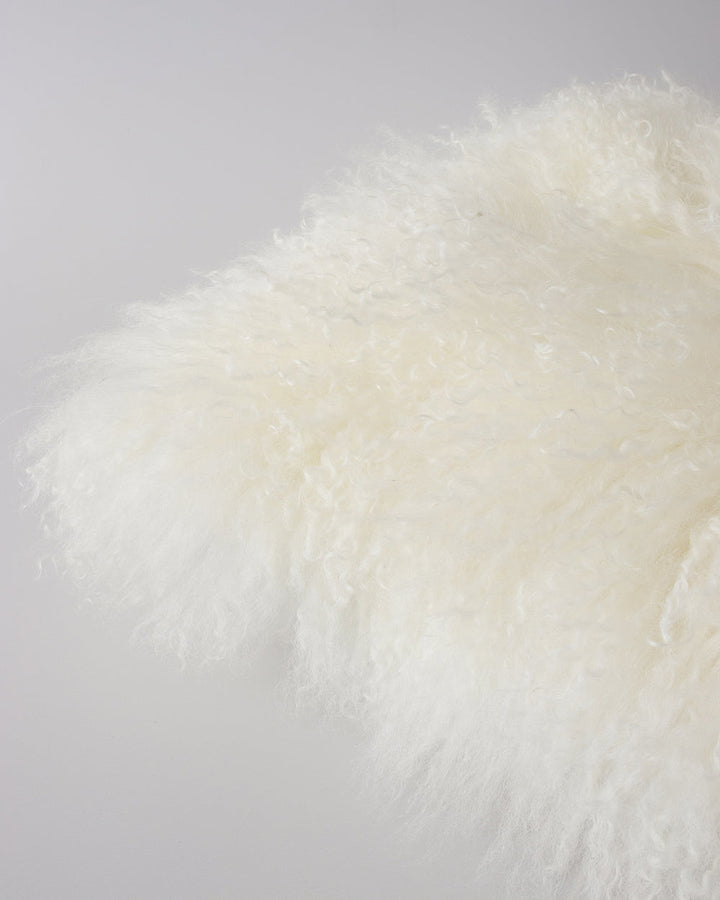 Meru Tibetan Lamb Cushion Bring a cosy, inviting feel to a room with the impossibly soft texture of Tibetan lamb fur. Gorgeously shaggy with a natural curl, the Meru engages senses with its sumptuous tactility, and restful silver tone. Style with matching