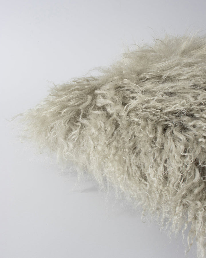 Meru Tibetan Lamb Cushion Bring a cosy, inviting feel to a room with the impossibly soft texture of Tibetan lamb fur. Gorgeously shaggy with a natural curl, the Meru engages senses with its sumptuous tactility, and restful silver tone. Style with matching