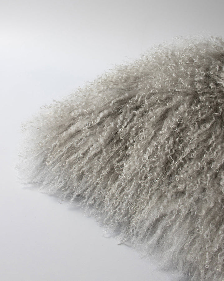 Meru Tibetan Lamb Cushion Bring a cosy, inviting feel to a room with the impossibly soft texture of Tibetan lamb fur. Gorgeously shaggy with a natural curl, the Meru engages senses with its sumptuous tactility, and restful silver tone. Style with matching