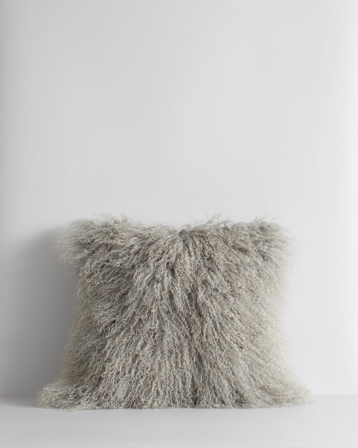 Meru Tibetan Lamb Cushion Bring a cosy, inviting feel to a room with the impossibly soft texture of Tibetan lamb fur. Gorgeously shaggy with a natural curl, the Meru engages senses with its sumptuous tactility, and restful silver tone. Style with matching