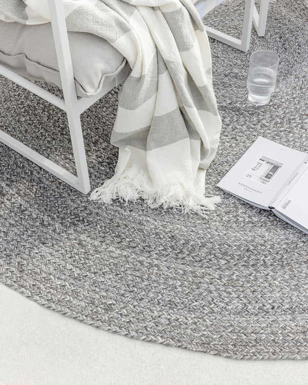 Mornington Floor Rug Our hand-braided Mornington rug is woven with 100% PET yarn, a soft and supple fibre produced by recycling plastic bottles. This eco-conscious rug can be used both indoors and outdoors, with its light tone creating an easy-going summe