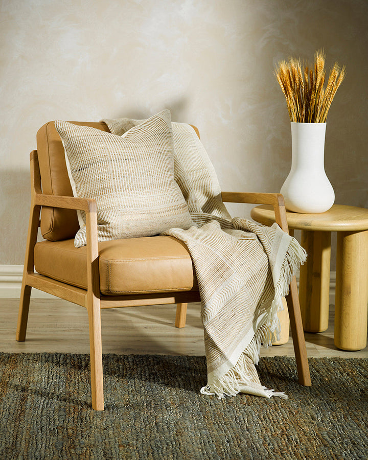 Navajo Cushion Constructed from sections of artisanal woven fabric, the Navajo is handcrafted using a stunning blend of wild tussar silk and spun wool. Celebrating natural fibres, the straw and ecru tones add a warm and artisan aesthetic to a space. Pair