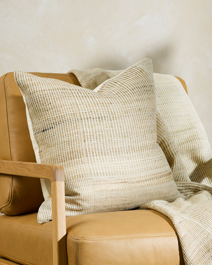 Navajo Cushion Constructed from sections of artisanal woven fabric, the Navajo is handcrafted using a stunning blend of wild tussar silk and spun wool. Celebrating natural fibres, the straw and ecru tones add a warm and artisan aesthetic to a space. Pair