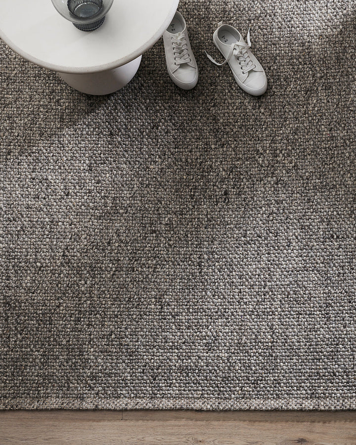 Nebraska Floor Rug Create a timeless living space with the with the beauty of this wool-blend floor rug in soft taupe. Handwoven in a simple 1-1 weave, the Nebraska adds warmth and interest with its subtle mottled tones and versatile structure. A staple f