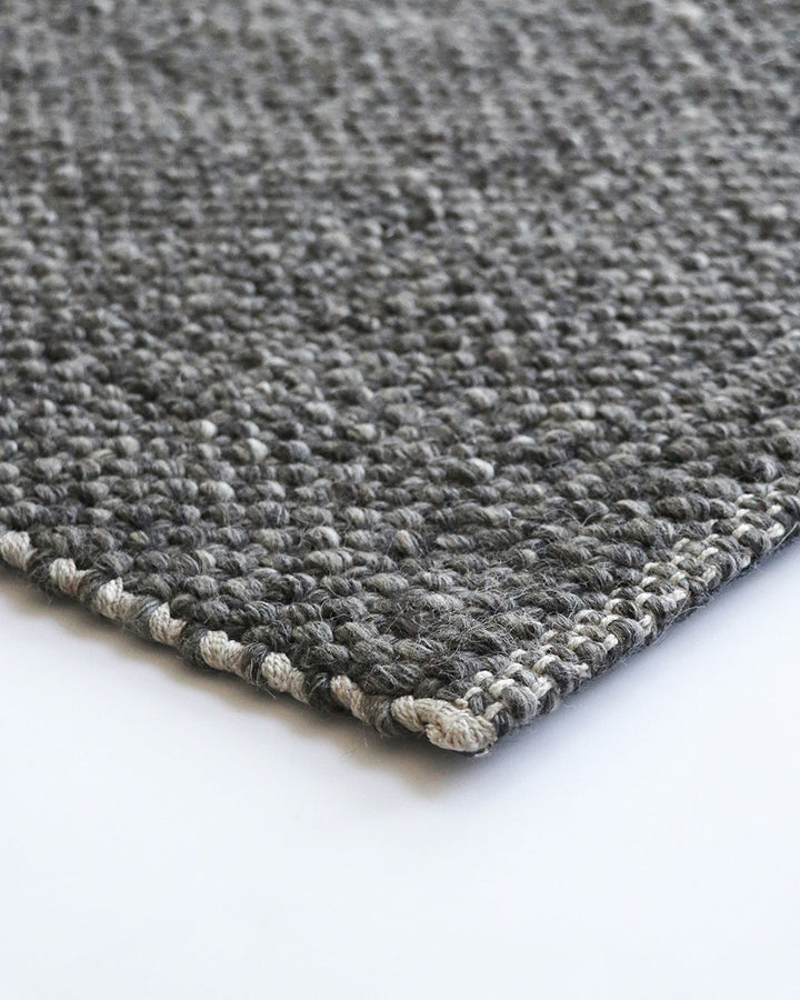 Nebraska Floor Rug Create a timeless living space with the with the beauty of this wool-blend floor rug in soft taupe. Handwoven in a simple 1-1 weave, the Nebraska adds warmth and interest with its subtle mottled tones and versatile structure. A staple f