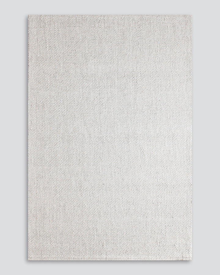 Nebraska Floor Rug Create a timeless living space with the with the beauty of this wool-blend floor rug in soft taupe. Handwoven in a simple 1-1 weave, the Nebraska adds warmth and interest with its subtle mottled tones and versatile structure. A staple f