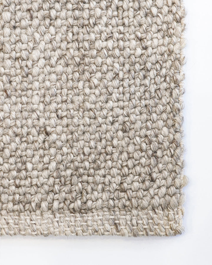 Nebraska Floor Rug Create a timeless living space with the with the beauty of this wool-blend floor rug in soft taupe. Handwoven in a simple 1-1 weave, the Nebraska adds warmth and interest with its subtle mottled tones and versatile structure. A staple f