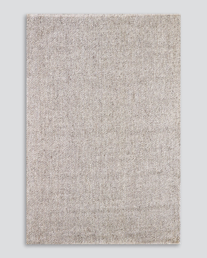 Nebraska Floor Rug Create a timeless living space with the with the beauty of this wool-blend floor rug in soft taupe. Handwoven in a simple 1-1 weave, the Nebraska adds warmth and interest with its subtle mottled tones and versatile structure. A staple f