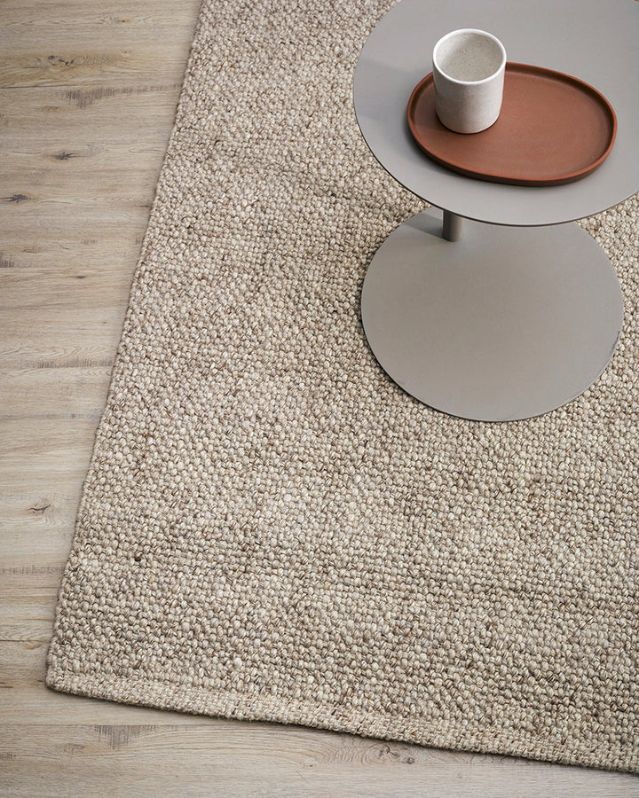 Nebraska Floor Rug Create a timeless living space with the with the beauty of this wool-blend floor rug in soft taupe. Handwoven in a simple 1-1 weave, the Nebraska adds warmth and interest with its subtle mottled tones and versatile structure. A staple f