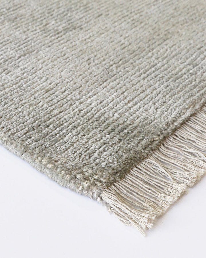 Nolan Floor Rug Hand-knotted from a velvety blend of bamboo silk and wool, the Nolan is perfect for formal living spaces and lavish bedrooms. Featuring a delicate short fringe and a soft mid-height pile, this understated floor rug is both simple and luxur