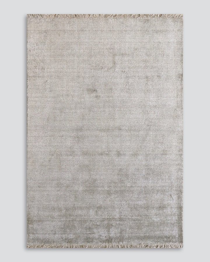 Nolan Floor Rug Hand-knotted from a velvety blend of bamboo silk and wool, the Nolan is perfect for formal living spaces and lavish bedrooms. Featuring a delicate short fringe and a soft mid-height pile, this understated floor rug is both simple and luxur