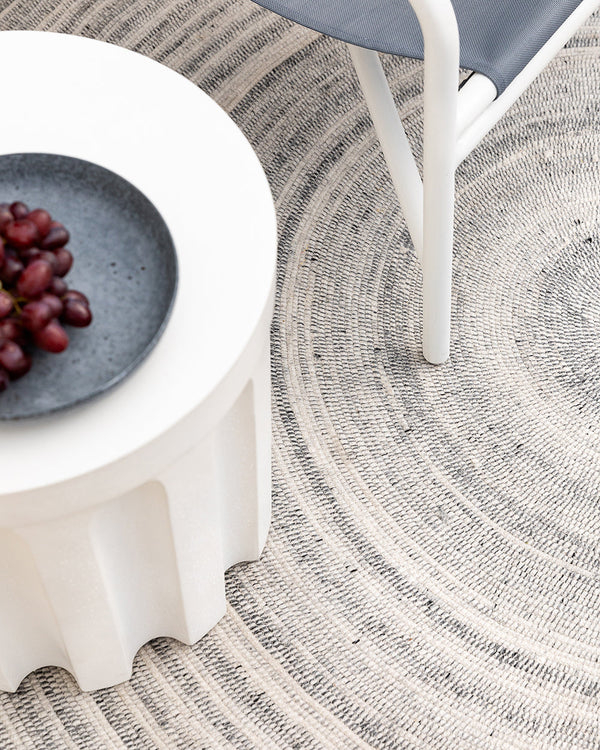 Palm Cove Floor Rug Enhance your outdoor space with the elegant circular design of Palm Cove. Featuring a mottled palette of pebble, brown and ivory tones, this versatile piece creates a welcoming space and is perfect for in and outdoor use. This floor ru
