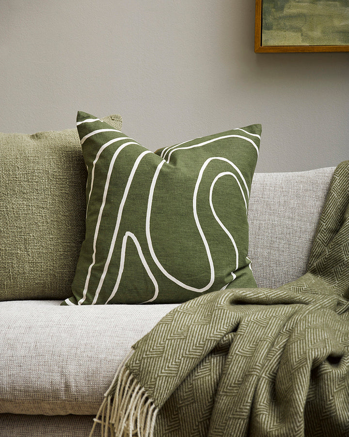 Picchu Cushion A mindful, harmonious way of living is reflected in the design of this olive-toned cushion. The flow of nature is subtly depicted with painterly lines, hand-drawn onto a linen-cotton base. Pair with ecru and moss tones to create a balanced