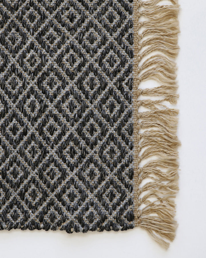 Reef Floor Rug Create a relaxing exterior setting with the handwoven texture and warm bark tone of our Reef floor rug. Handwoven from durable polypropylene, the Reef features a small scale diamond pattern and is finished with a casual, hand-knotted fringe