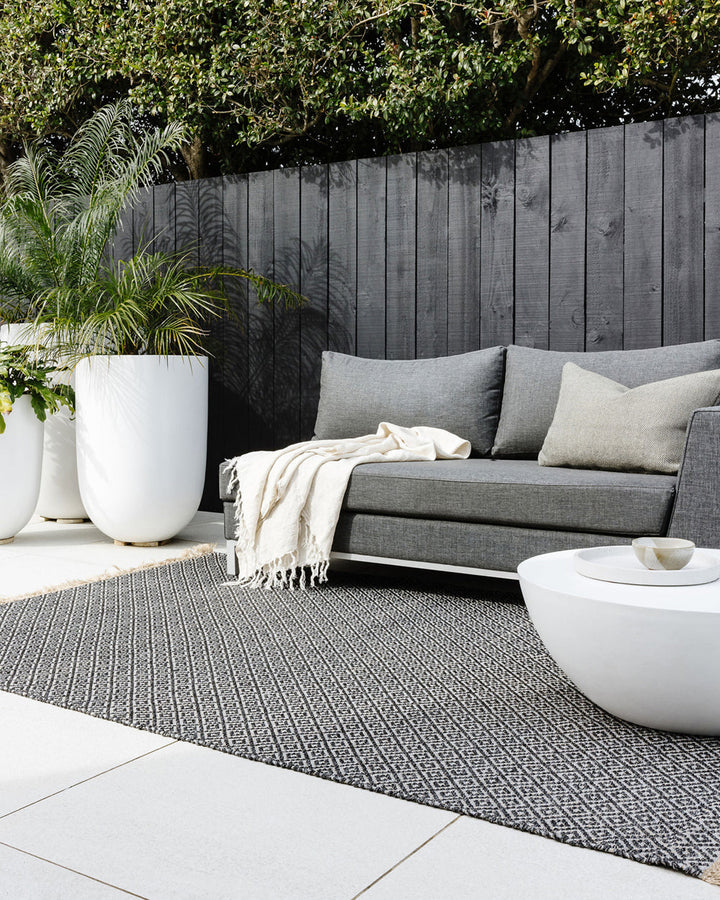 Reef Floor Rug Create a relaxing exterior setting with the handwoven texture and warm bark tone of our Reef floor rug. Handwoven from durable polypropylene, the Reef features a small scale diamond pattern and is finished with a casual, hand-knotted fringe