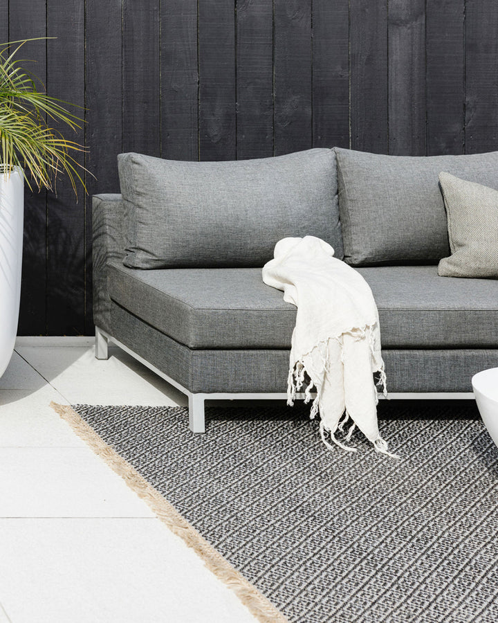 Reef Floor Rug Create a relaxing exterior setting with the handwoven texture and warm bark tone of our Reef floor rug. Handwoven from durable polypropylene, the Reef features a small scale diamond pattern and is finished with a casual, hand-knotted fringe