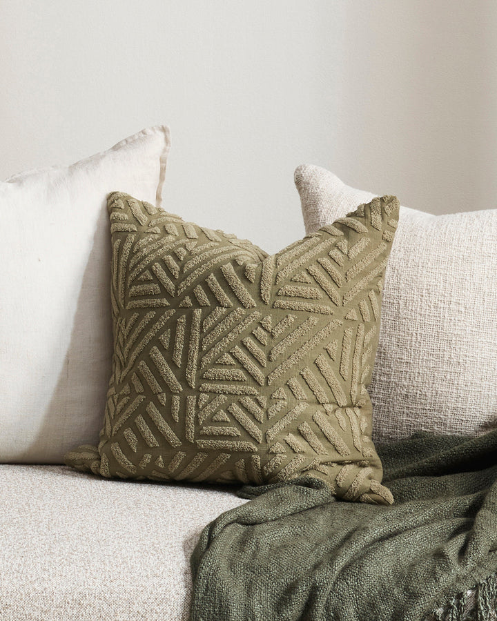 Remus Cushion Tufted embroidery on a natural base forms the texture on this relaxed and expressive cushion. Centred on a serene colour palette of ecru and taupe, the subtly tribal surface design looks great paired with finely woven linens in neutral and c